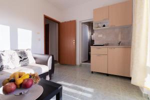 a living room with a couch and a table with fruit on it at Apartment Dragicevic 3 with Garage in Budva