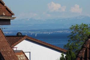 a view of the ocean from the roofs of buildings at Am Strandweg in Überlingen