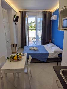 a small room with a bed and a table with a tablektop at Punticello House in Procida