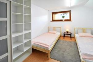 a bedroom with two bunk beds and a window at Willa Dom wakacyjny Zakątek in Kołobrzeg