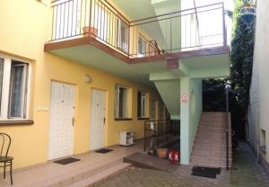a building with a staircase and a balcony on it at Hostel Malva in Łomianki