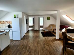 a kitchen and living room with a white refrigerator at Twins Apartments Sovata in Sovata
