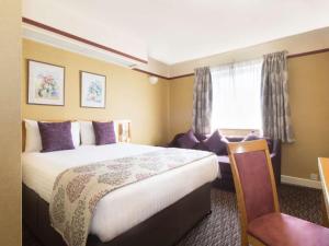 A bed or beds in a room at Derby Station Hotel, Sure Hotel Collection by Best Western 