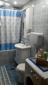 a bathroom with a toilet and a sink at Apartman Lux K in Bijeljina +14 photos