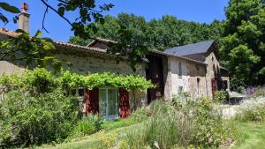 una casa vieja con vides a un lado. en L´Aveneau, en Le Retail