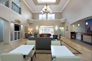 a lobby of a hospital with tables and chairs at Sonesta Essential Houston Westchase in Houston
