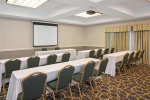 a conference room with tables and chairs and a screen at Sonesta Essential Houston Westchase in Houston +36 photos