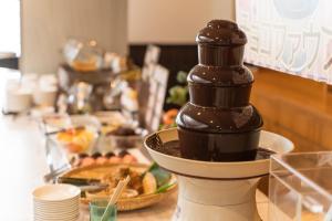 a chocolate syrup dispenser sitting on a table with food at Hotel Ocean (Kokusai-Dori) in Naha