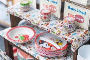a table with plates and bowls on a shelf at Hotel Ocean (Kokusai-Dori) in Naha