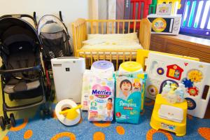 a childs bedroom with a crib and some toys at Hotel Ocean (Kokusai-Dori) in Naha