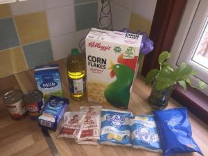 a counter with a bag of corn flakes and other snacks at Beautiful Bungalow Home Droitwich SPA in Droitwich