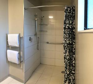 a bathroom with a shower with a glass door at Adelaide Motel in Wellington