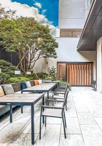 a row of tables and benches on a patio at Parkview Taipei in Taipei