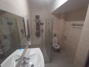 a bathroom with a sink and a shower and a toilet at MaraVali Seaview Mamaia in Mamaia +11 photos