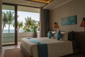 a bedroom with a bed with a view of the ocean at Mia Resort Nha Trang in Nha Trang
