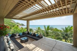 a balcony overlooking a beach with a view of the ocean at Mia Resort Nha Trang in Nha Trang