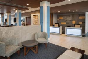 a lobby with chairs and a counter with a waiting room at Holiday Inn Express Knoxville-Strawberry Plains, an IHG Hotel in Knoxville
