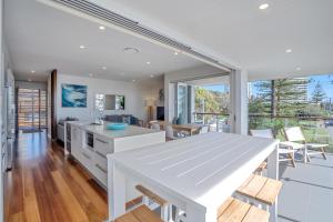 a kitchen and living room with a large window at Bujerum Apartments on Burleigh in Gold Coast