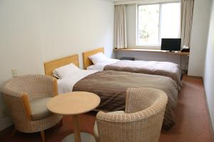 Tempat tidur dalam kamar di Nishiizu Crystal View Hotel