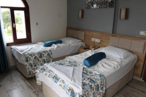 Ein Bett oder Betten in einem Zimmer der Unterkunft Eroglu City Hotel