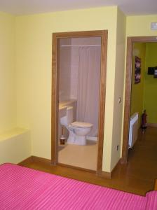 a bathroom with a white toilet in a room at La Casa Nueva in Nieva de Cameros