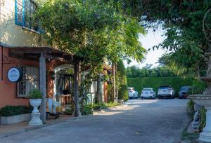 a street in front of a building with cars parked at Hotel Toscana Trat in Trat