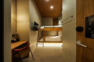 a small room with a bunk bed and a desk at mizuka Imaizumi 2 - unmanned hotel - in Fukuoka