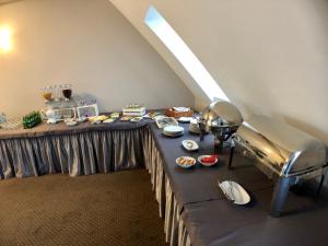 a long table with food on it in a room at Hotel Nad Stawem in Skalbmierz