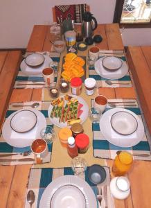 a wooden table with plates and food on it at Utamaduni House B&B in Arusha +50 photos