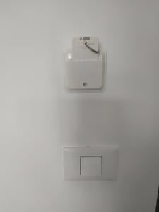 a white electrical outlet on a white wall at ENALION-TINOS in Tinos