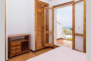 a room with a bed and a window with a balcony at GRAN VISTA in Santa Pola