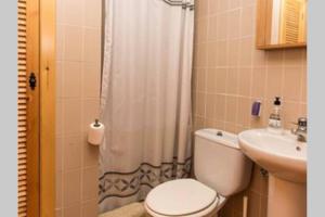 a bathroom with a toilet and a sink at GRAN VISTA in Santa Pola +14 photos