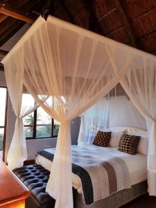 Un pat sau paturi într-o cameră la Camp Acacia
