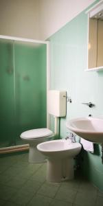 een badkamer met 2 toiletten en een wastafel bij VILLA ANTONIETTA in Cesenatico