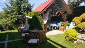 a gazebo with a table and chairs in a yard at Happy Home in Budikovany