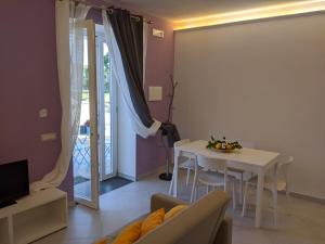 a living room with a white table and a table and a couch at Punticello House in Procida