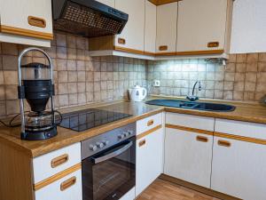 a kitchen with a sink and a coffee maker at Ferienhaus Waldidyll in Lemgo