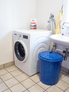 a washing machine in a bathroom with a sink at Ferienhaus Waldidyll in Lemgo