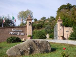 a large stone building with a statue of a bear on top of it at Agriturismo Montemari in Palaia