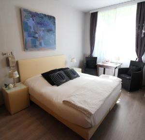 Postel nebo postele na pokoji v ubytování Hotel Georges