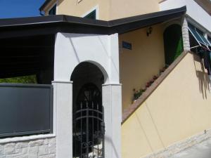 an entrance to a building with a black gate at Apartment Mamut in Premantura