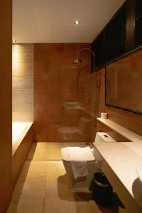 a bathroom with a toilet and a sink and a shower at Phor Liang Meun Terracotta Arts in Chiang Mai