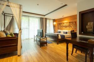 a bedroom with a bed and a desk and a piano at Phor Liang Meun Terracotta Arts in Chiang Mai