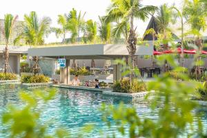 a pool at a resort with palm trees at Anantara Vacation Club Mai Khao Phuket in Mai Khao Beach