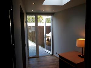 a hallway with a sliding glass door leading to a patio at Vakantiewoning FINE FLEUR in Bruges