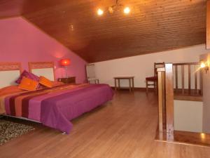 a bedroom with a large bed and a wooden ceiling at Solar de Rabal in Bragança