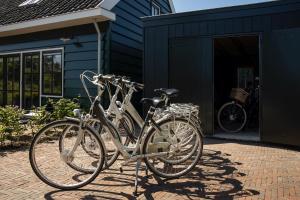 two bikes are parked outside of a house at Saenliefde in Wormer