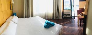a hotel room with a white bed and a desk at Best Western Hotel Mediterraneo in Castelldefels +57 photos