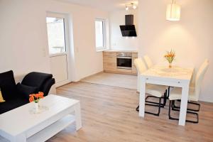 a living room with a table and a dining room at Ferienwohnung Familie Raasch in Baabe