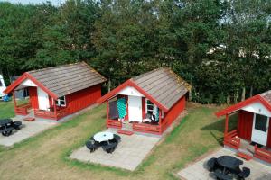 an overhead view of a red house with a table and chairs at Bredebro camping in Bredebro